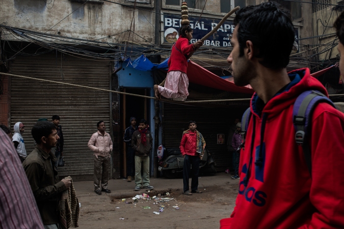 girl performing acrobatic stunts on streets of chandni chowk